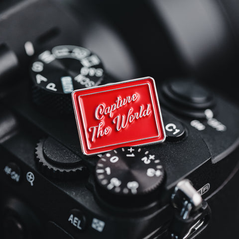 Capture the World Enamel Pin